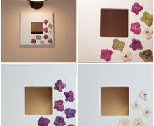 Mirror in white lacquered wooden frame. real flowers covered with transparent resin