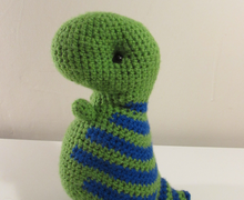 Green dinosaur with blue stripes