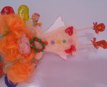 A fairy flies on balloons (toy souvenir). Head, arms and legs move
