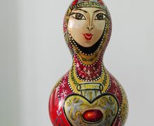 Woman Drawing on Dried Pumpkin