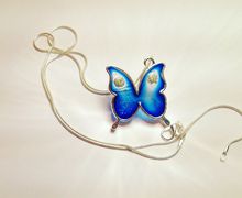 Silver necklace with pendant. Blu resin butterfly and flowers