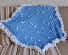 A blue blanket with ruche