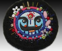 A black boho-style pin