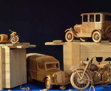Wooden toy cars and a motorcycle
