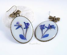 Big earrings with larkspur blossom clusters
