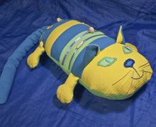 A pillow in a form of a cat