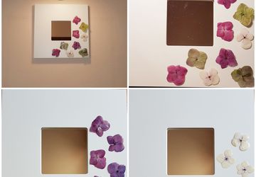 Mirror in white lacquered wooden frame. real flowers covered with transparent resin