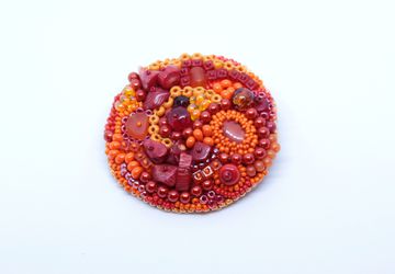 Orange red beadwork brooch