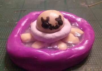 Octopus in pool with a swimming ring on polymer clay figure