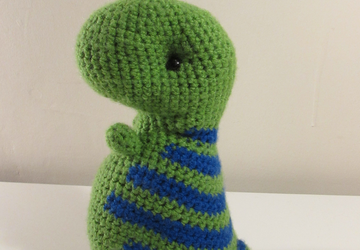 Green dinosaur with blue stripes