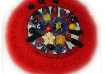 A red Boho-style pin