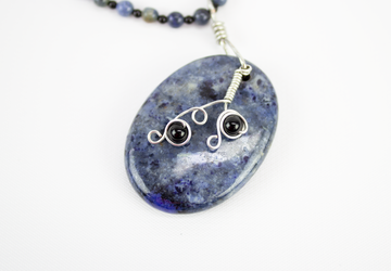 Blue dumortierite and onyx stone beaded necklace with large oval pendant and silver plated wirework accents