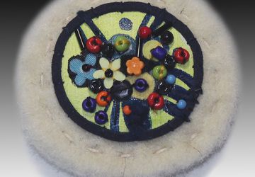 A white boho-style pin