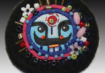 A black boho-style pin