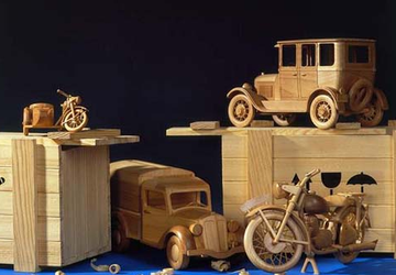 Wooden toy cars and a motorcycle