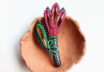 One of a kind polymer clay flower brooch in black and red tones decorated with glass crystals