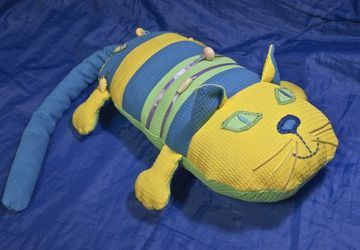 A pillow in a form of a cat